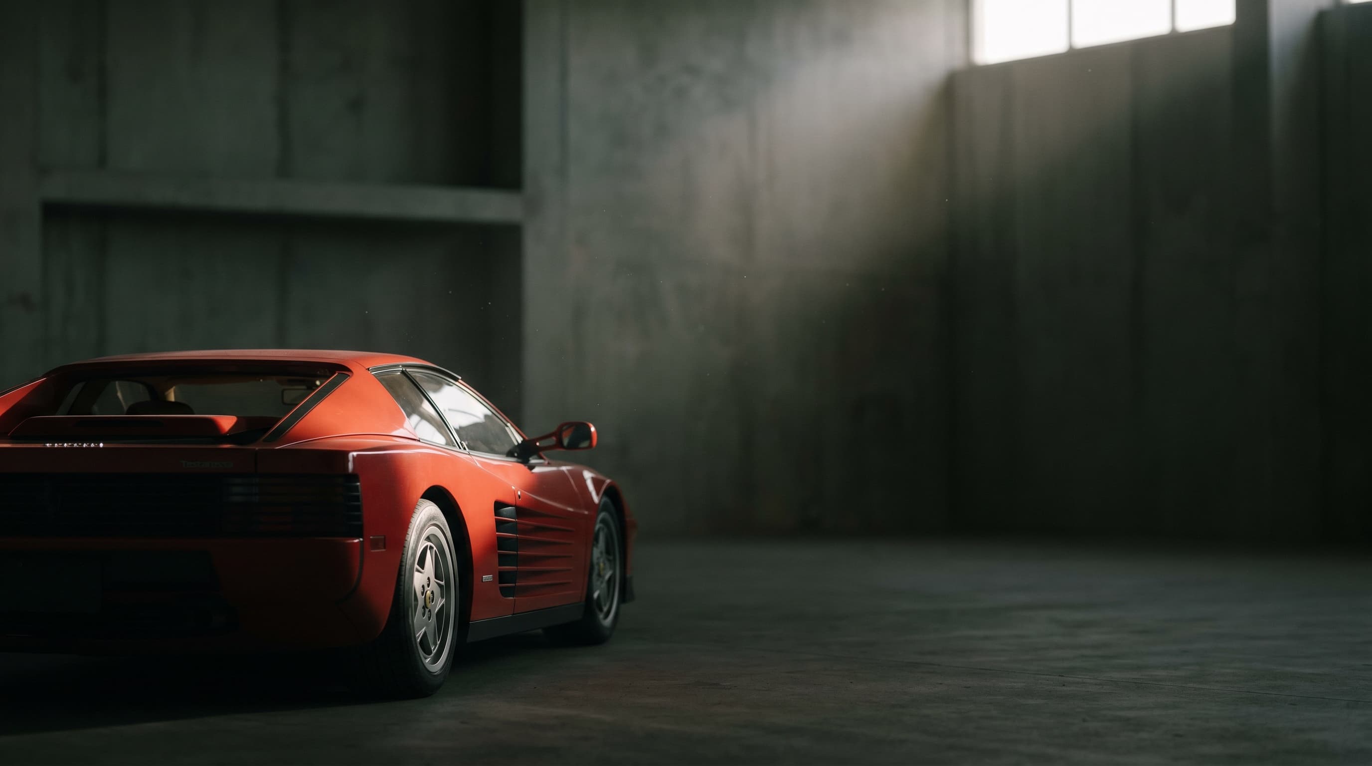 A red Ferrari resting in shadow